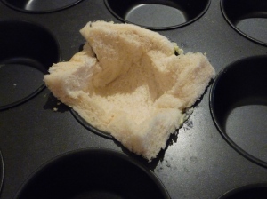 Press buttered bread into a muffin tin