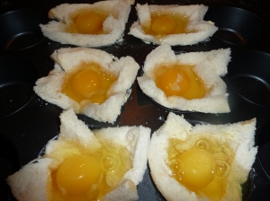 Crack eggs into bread