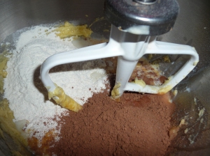 Add in the flour, cocoa and milk